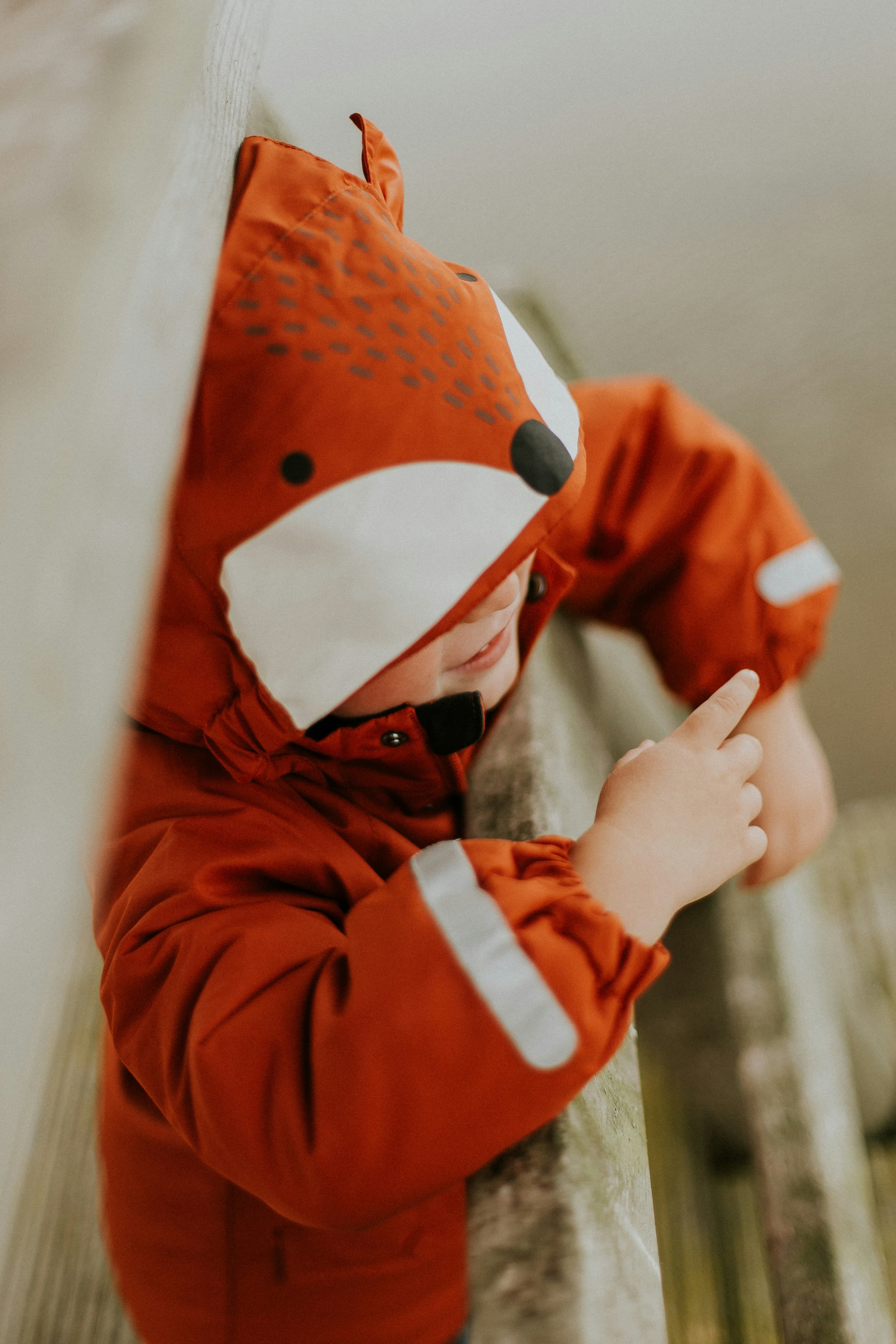 Toddler wearing cozy orange fox jacket by Child Cloth